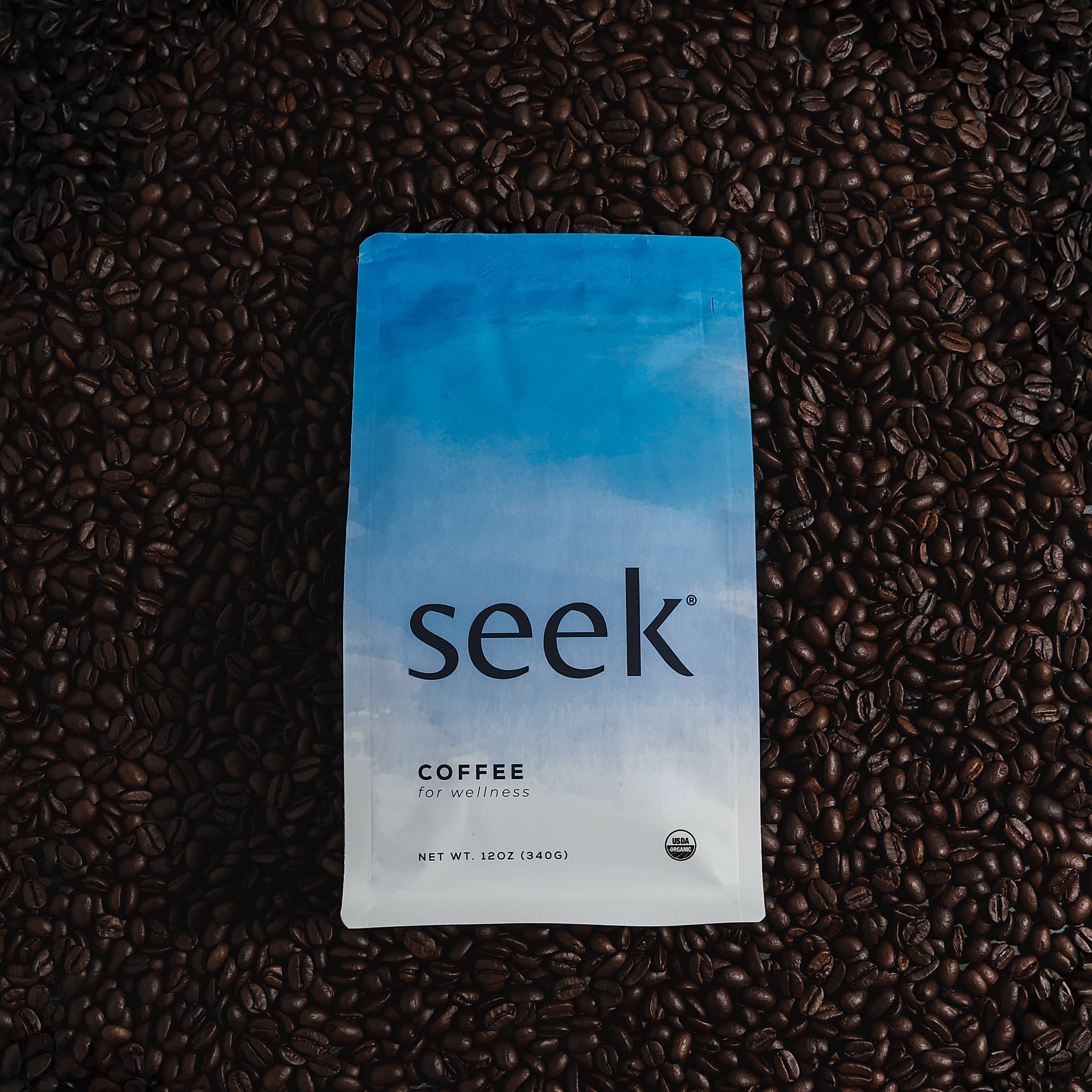 Seek coffee package on a bed of coffee beans