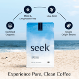 A bag of Seek® Mold-Free Coffee on a beach with icons highlighting Certified Organic, Mold & Mycotoxin Free, Low Acid, and Single Origin Beans.