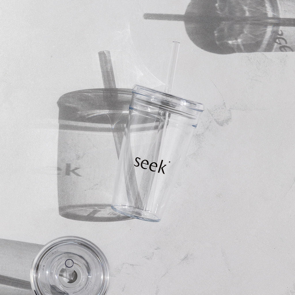 Clear tumblers with 'seek' branding on a light gray background