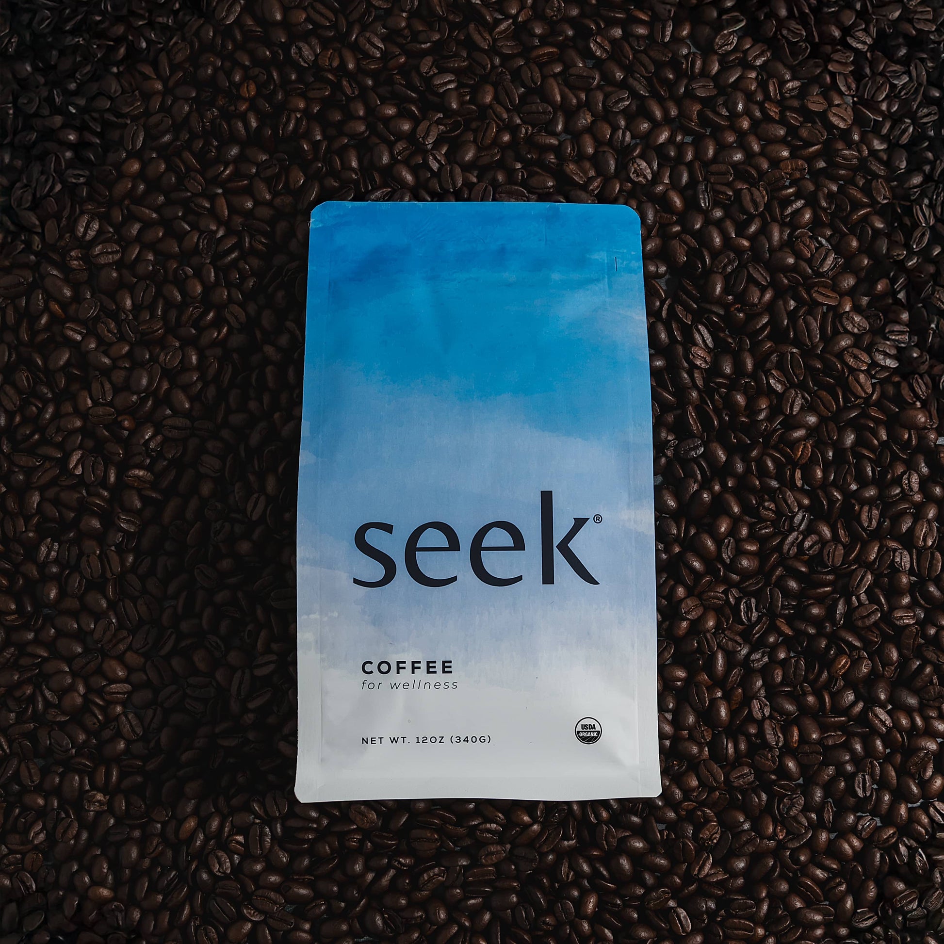 Seek coffee package on a bed of coffee beans