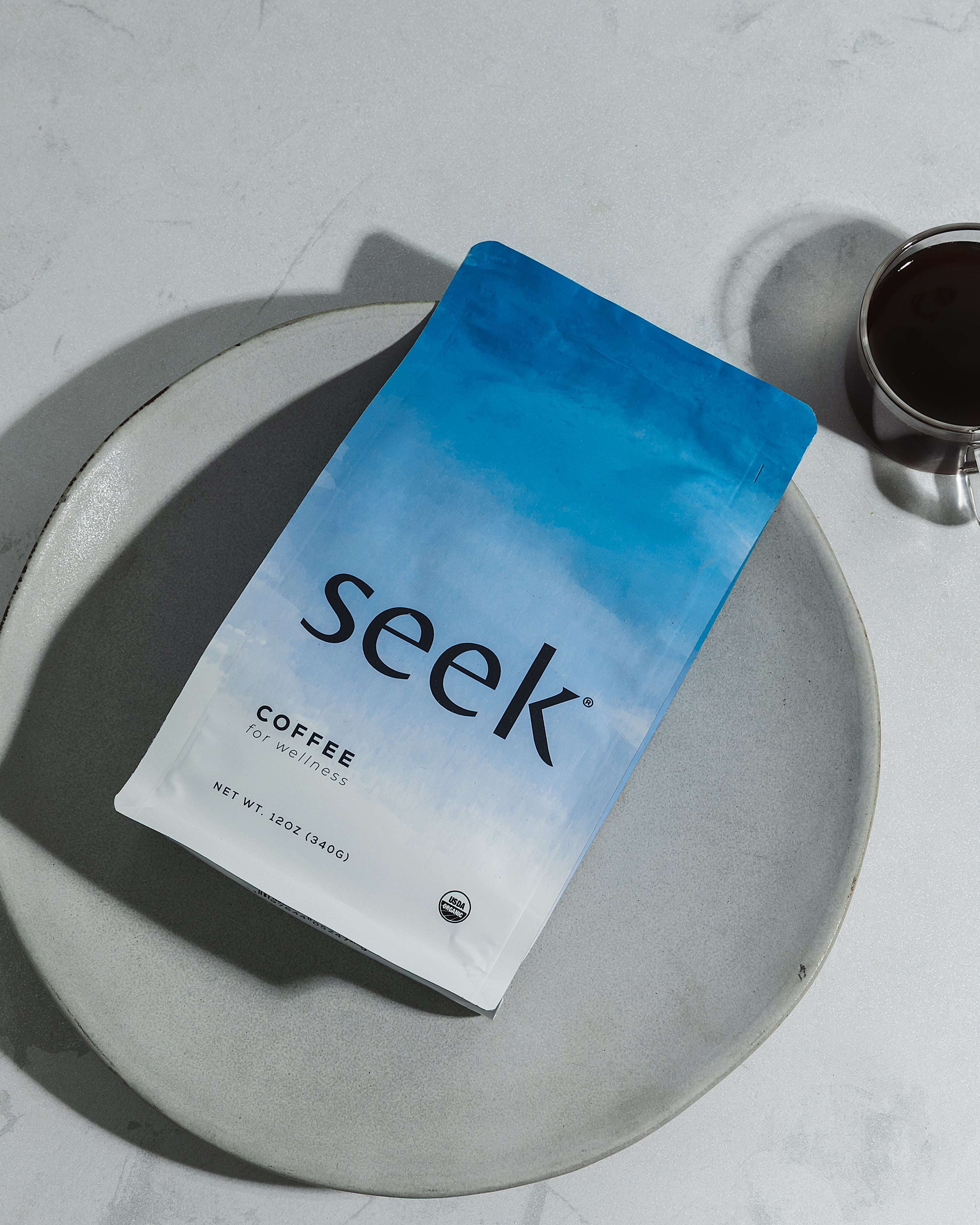 Seek coffee package on a gray plate with a white background