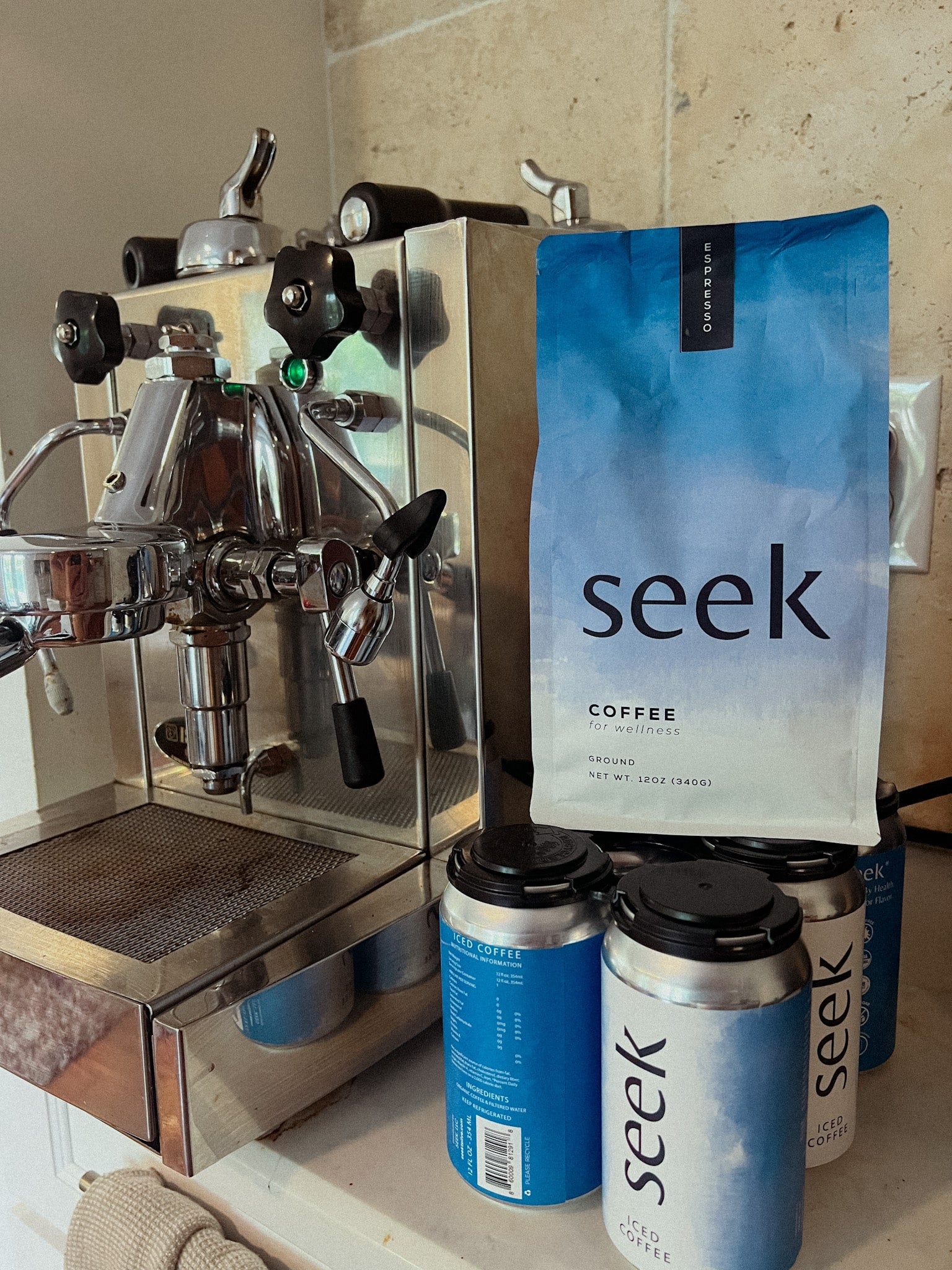 A bag of seek® organic mold free espresso sitting next to a professional espresso machine 